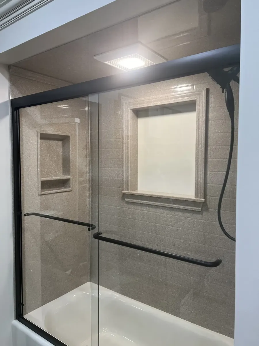 Linen-gray textured solid-surface tub surround with a built-in niche