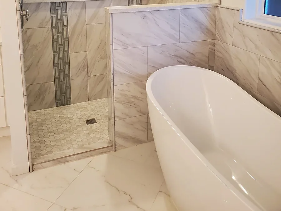 Master bathroom with a tiled walk-in shower and freestanding tub