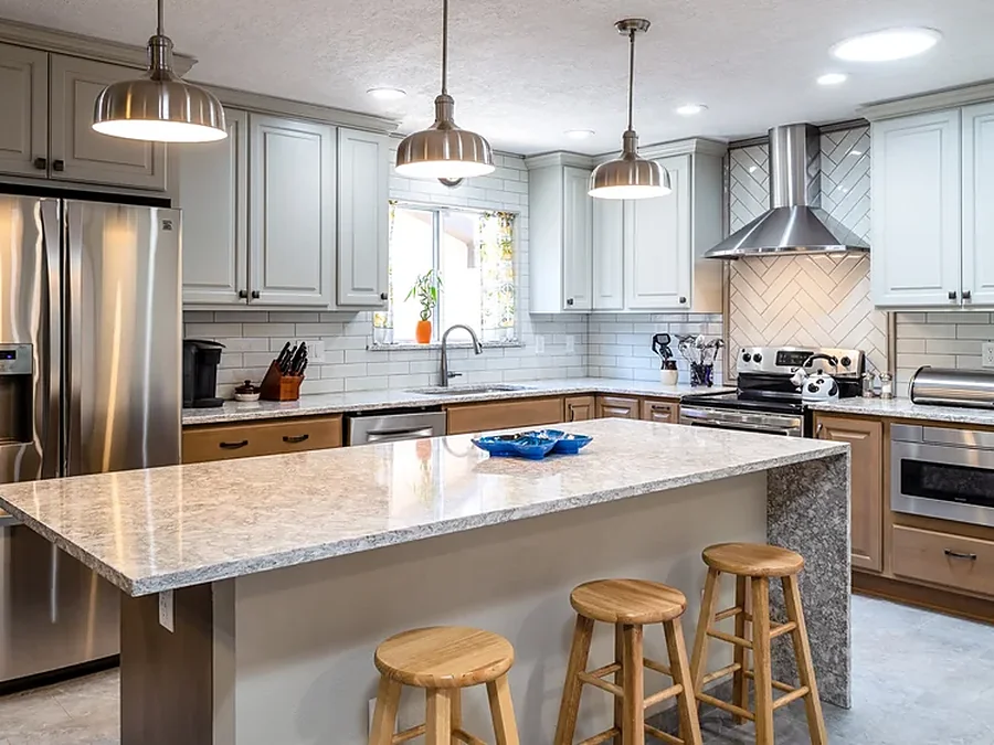 Kitchen remodel with a granite island and pendant lighting